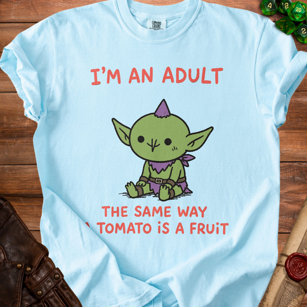 Light blue t-shirt with cartoon goblin and text: "I'M AN ADULT THE SAME WAY TOMATO IS A FRUIT."
