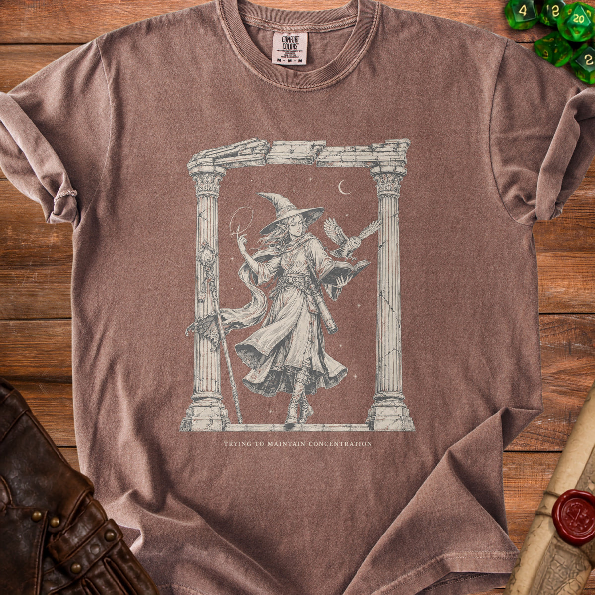 T-shirt with a line drawing of a witch and owl beneath Greek columns, text reads "Trying to Maintain Concentration".