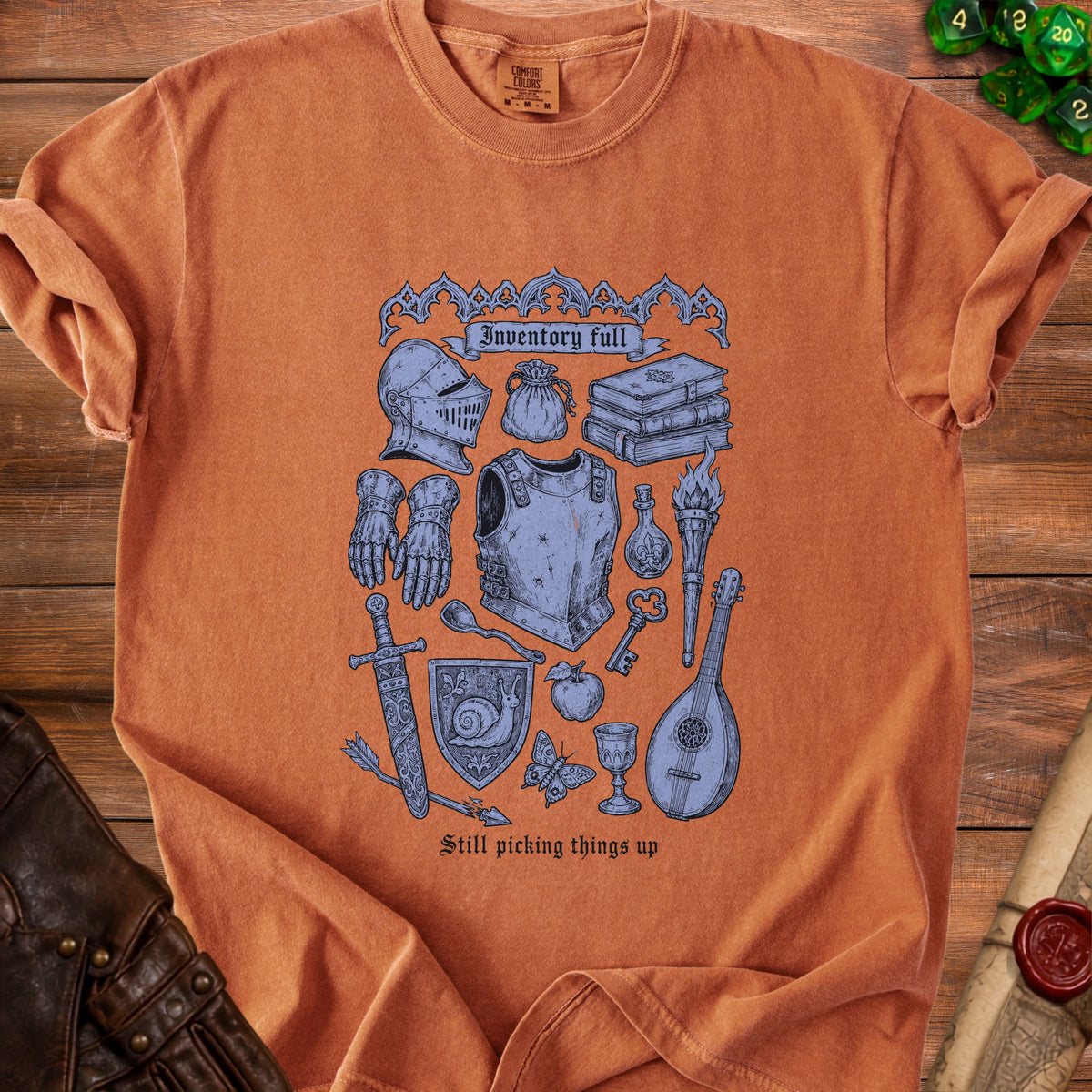 Orange t-shirt with medieval inventory graphic and text "Inventory full" and "Still picking things up".