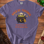 Purple t-shirt with skull and cauldron graphic and text "Hold Up, Partner" and "I'm Overstimulated And Fermenting Rage".