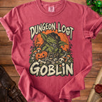 Dungeon Loot Goblin graphic tee featuring a green goblin, pumpkin, treasure chest, and dice.
