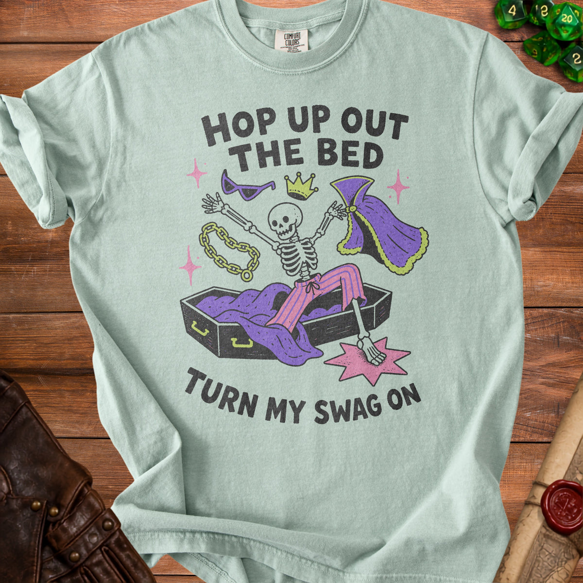 Light blue t-shirt with skeleton text "HOP UP OUT THE BED TURN MY SWAG ON".