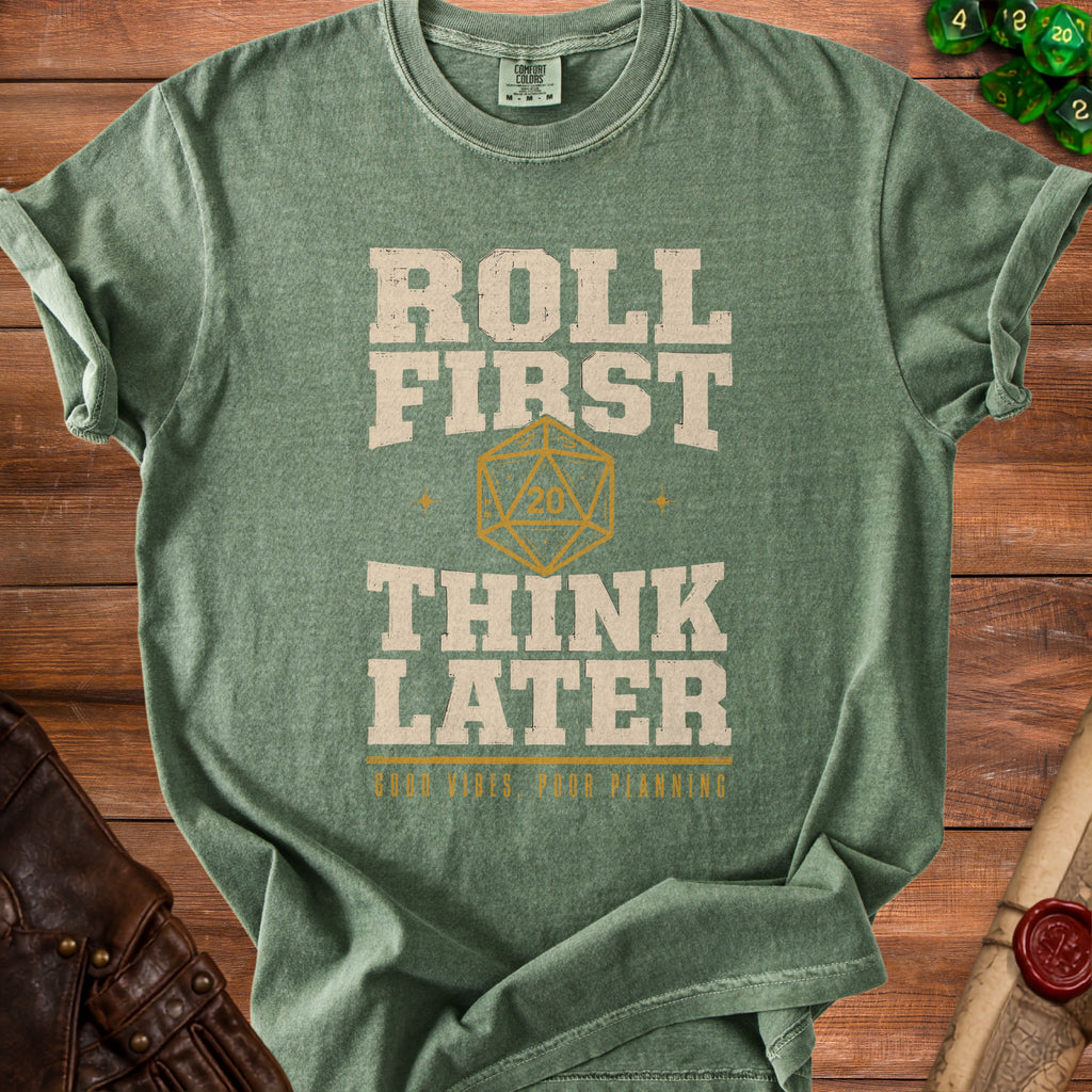 Green t-shirt with "Roll First Think Later" text and d20 dice graphic.