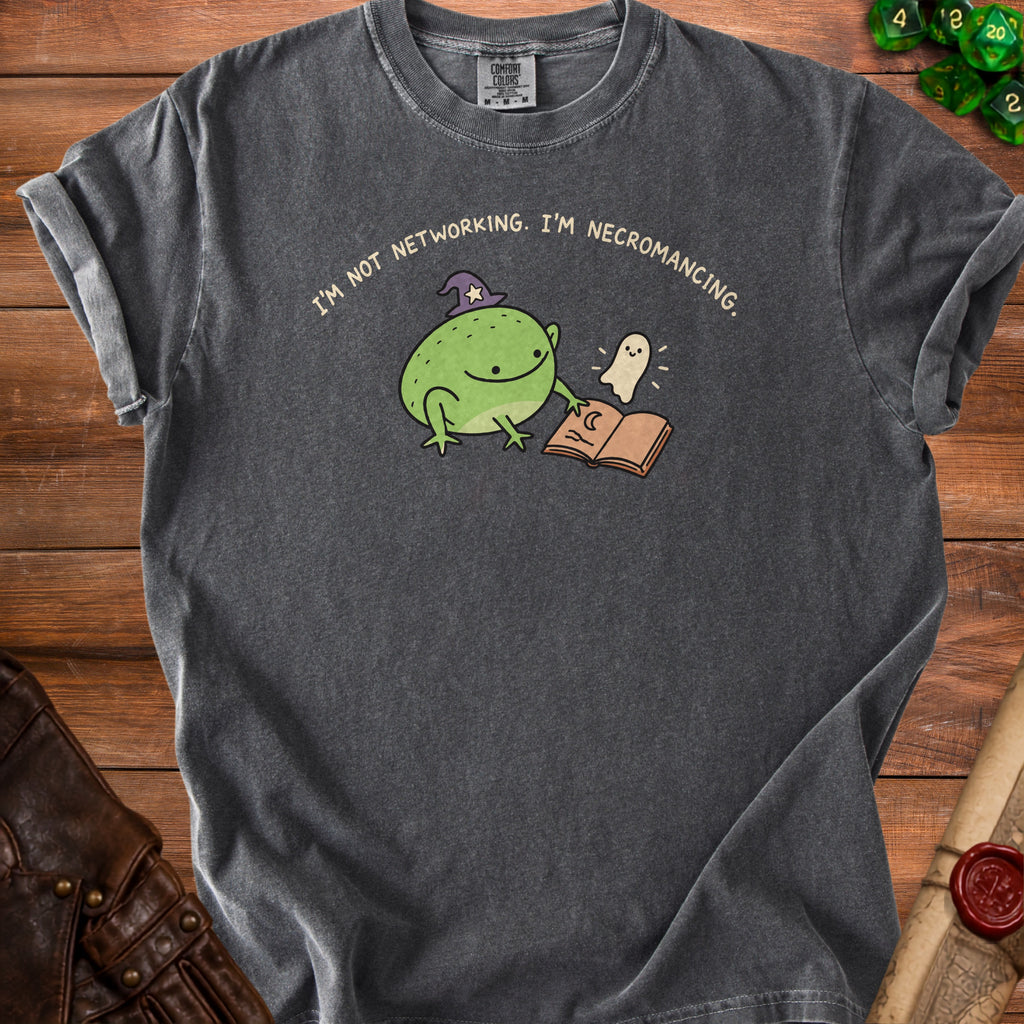 Dark grey t-shirt with a frog in a wizard hat and a ghost reading a book.