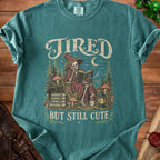 Tired but still cute graphic tee with skeleton witch reading a book.