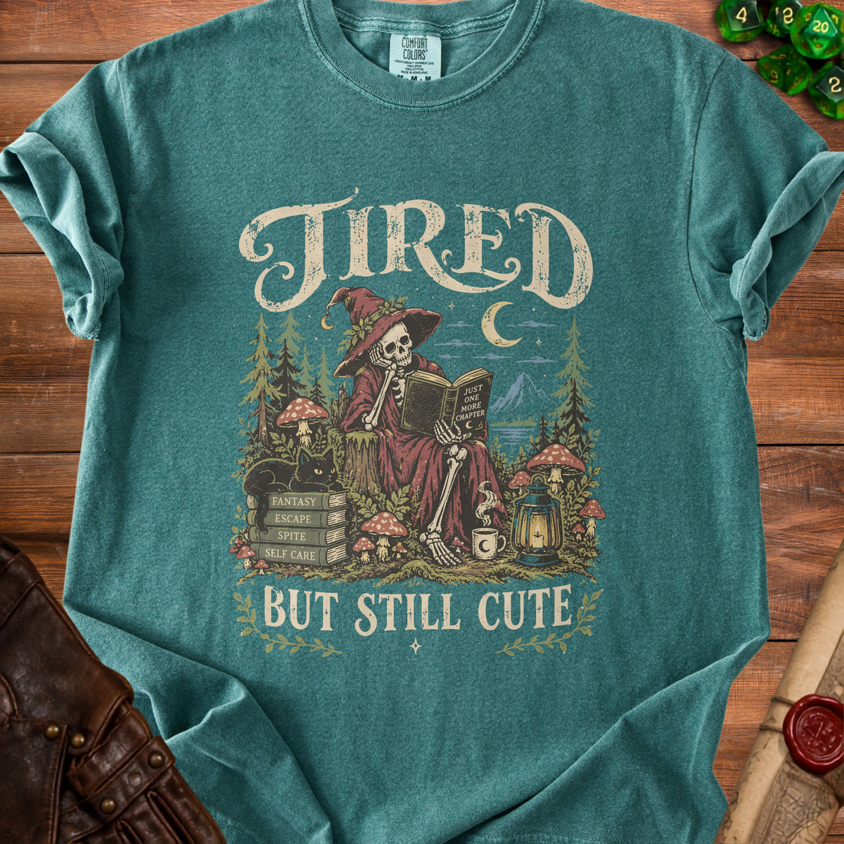 Tired but still cute graphic tee with skeleton witch reading a book.