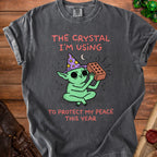 Green creature in wizard hat holds brick with text "The crystal I'm using to protect my peace this year".