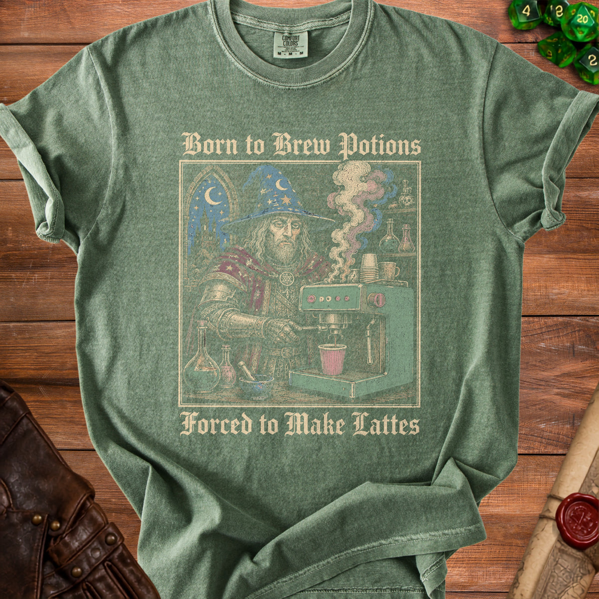 Green t-shirt with wizard making coffee. Text reads "Born to Brew Potions Forced to Make Lattes".