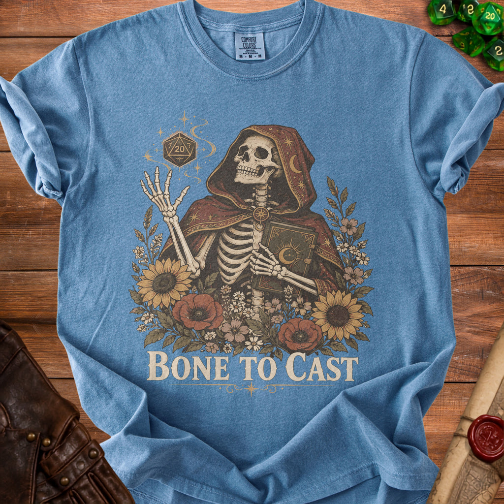 Skeleton in hooded robe holding a book and a d20 dice with flowers and text "Bone To Cast".