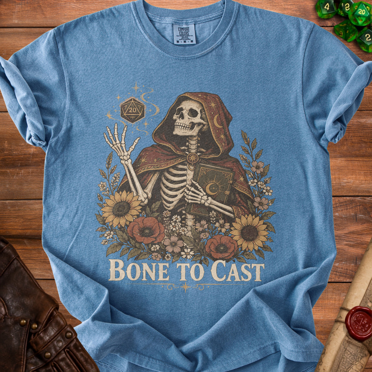 Skeleton in hooded robe holding a book and a d20 dice with flowers and text "Bone To Cast".