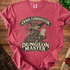 Red t-shirt featuring a goblin wearing a wizard hat, holding a checklist and a die, with text reading Chaos Coordinator Dungeon Master.