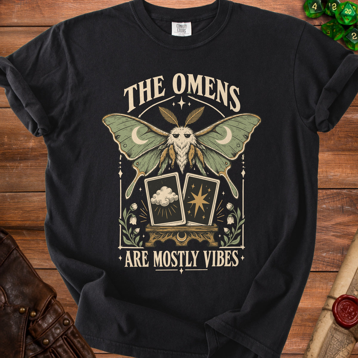 Black t-shirt with moth, tarot cards, and text "The Omens Are Mostly Vibes."