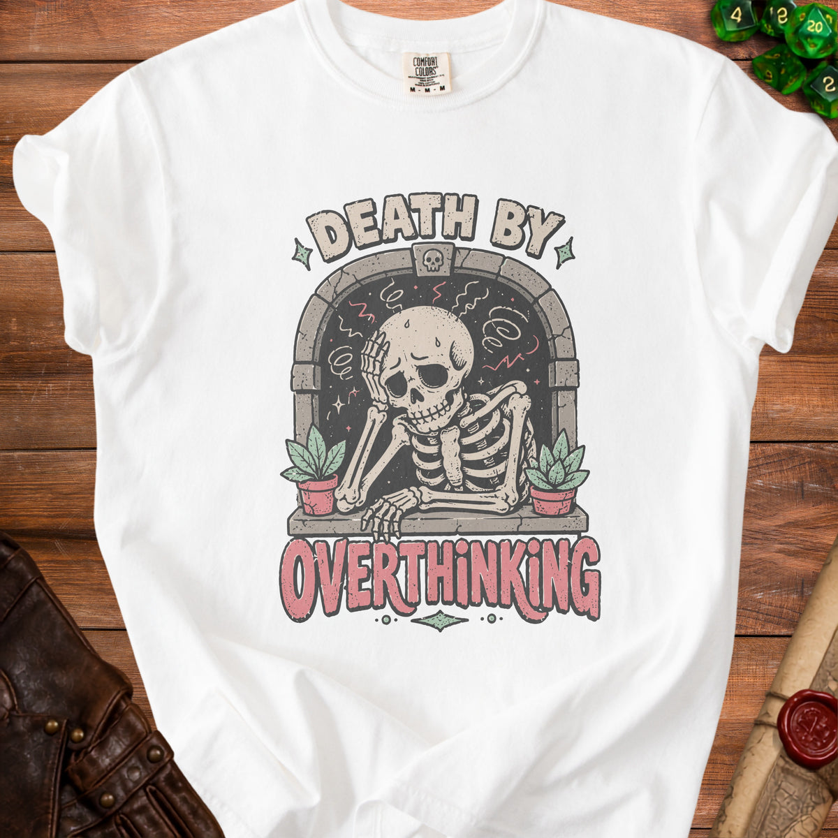 White t-shirt with skeleton overthinking graphic and text "DEATH BY OVERTHINKING".