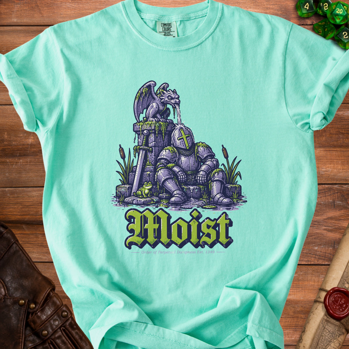 Teal t-shirt with "Moist" text featuring a gargoyle pouring water on a knight.