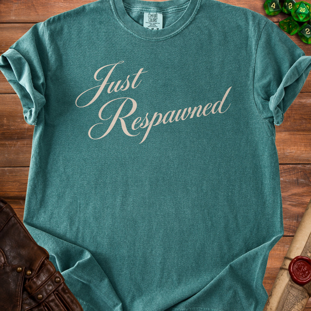 Teal t-shirt with "Just Respawned" in cream cursive font.