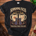 Black t-shirt with text "Summoning Focus" and "The Ritual Takes Two Cups".