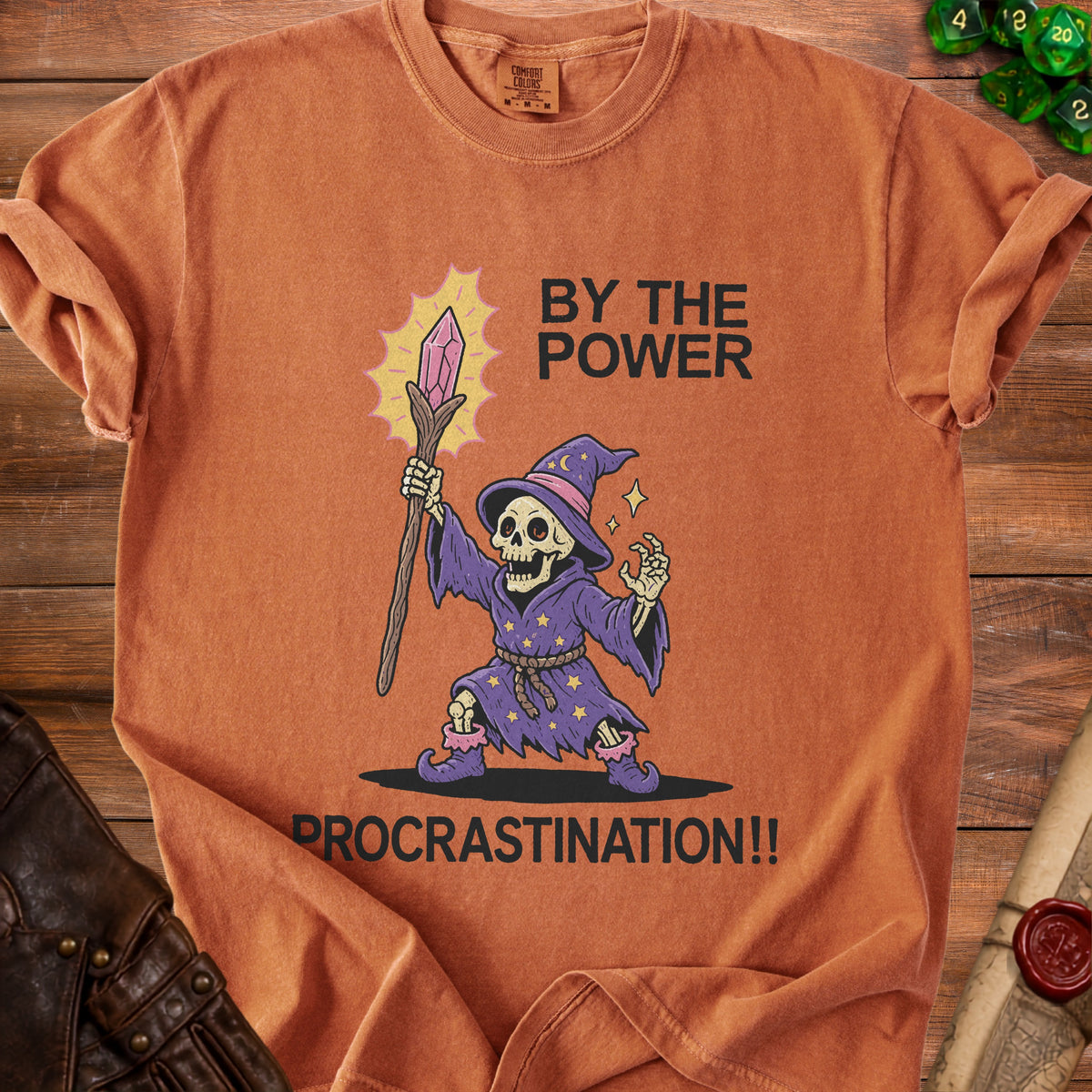 Orange t-shirt with skeleton wizard graphic and text "BY THE POWER PROCRASTINATION!!".