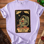 Tarot card design featuring a cat playing video games with text "ONE MORE GAME I SWEAR".