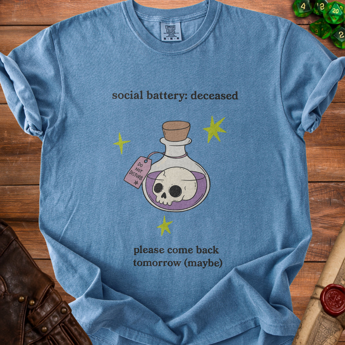 Blue t-shirt with "social battery: deceased" and a skull potion bottle.