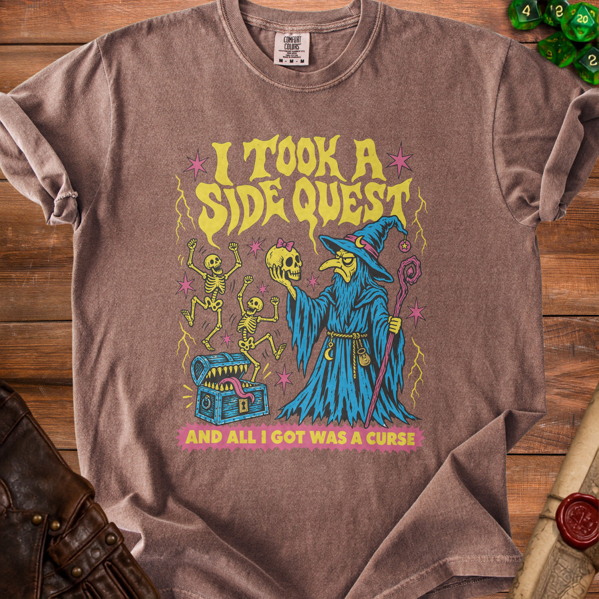 Brown t-shirt with "I took a side quest and all I got was a curse" text and graphics.