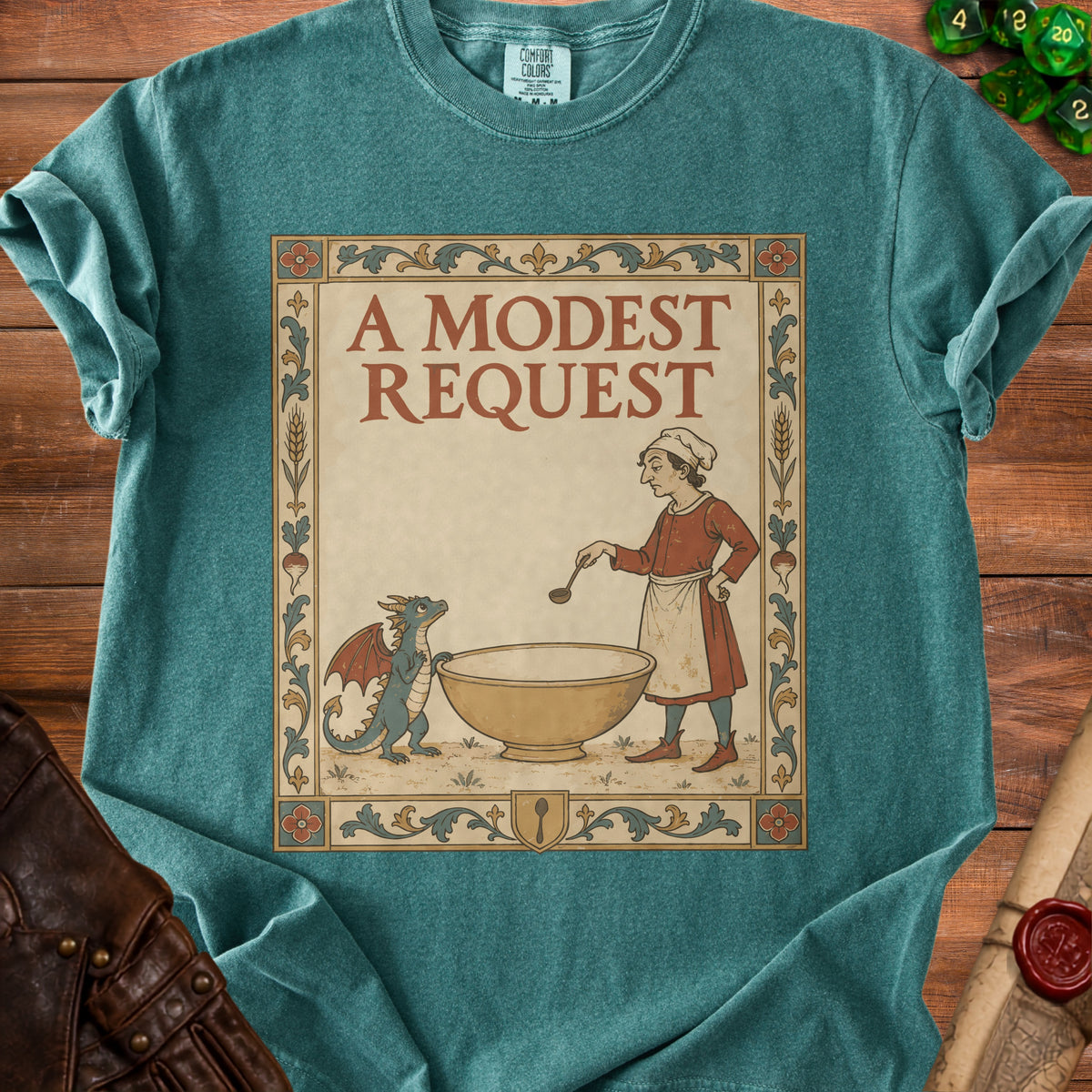 Teal t-shirt with illustration of a chef and dragon, text "A MODEST REQUEST".