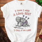 White t-shirt with a knight kneeling, arrows in back, and text "I THINK I NEED A LONG REST I CALL IT MY LORE".