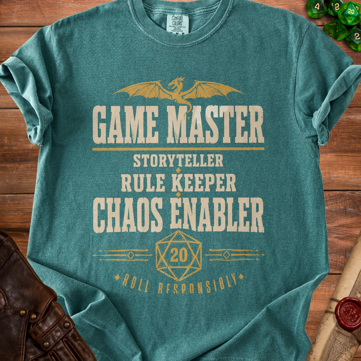 Teal t-shirt with "GAME MASTER STORYTELLER RULE KEEPER CHAOS ENABLER ROLL RESPONSIBLY" text.