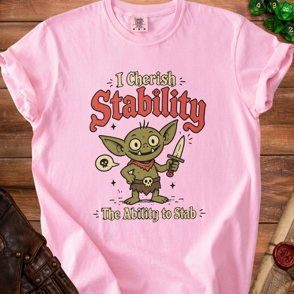Pink t-shirt with a cartoon goblin holding a dagger and text "I Cherish Stability The Ability to Stab".