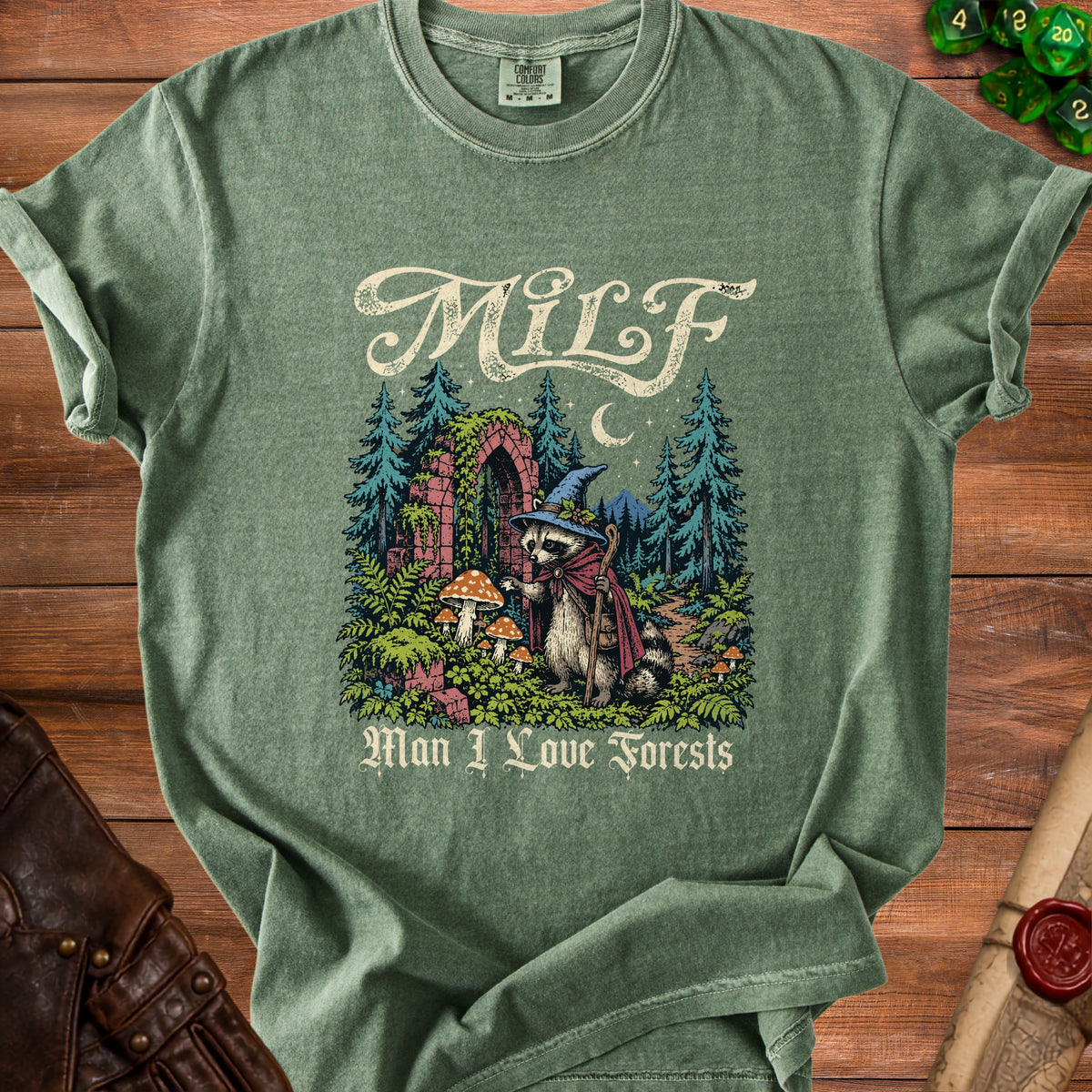 Green t-shirt with a raccoon in a witch hat and the text "MILF Man I Love Forests".