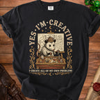 Opossum wearing a Viking helmet, planning on a map. Text says "YES. I'M CREATIVE. I CREATE ALL OF MY OWN PROBLEMS."