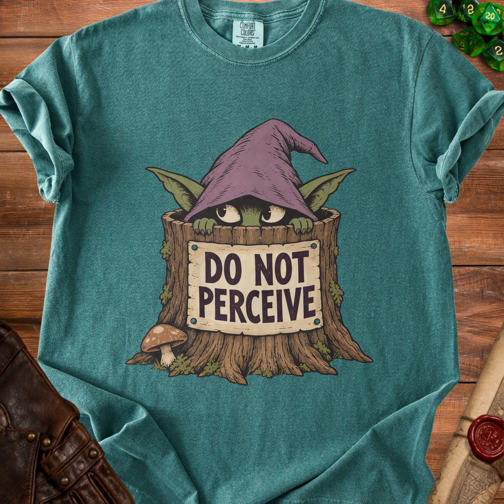 Teal t-shirt with goblin in tree stump saying "DO NOT PERCEIVE."