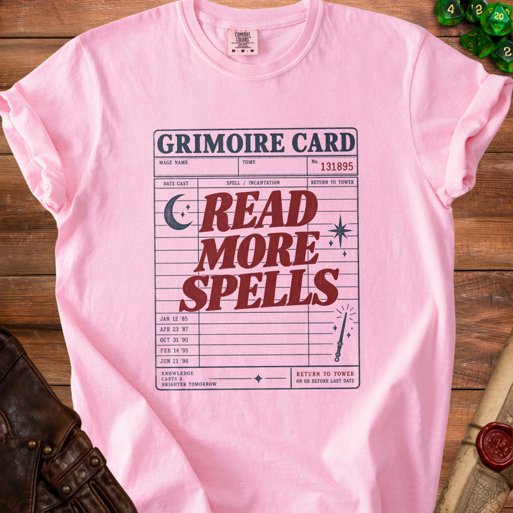 Pink t-shirt with "Grimoire Card" design reading "Read More Spells".