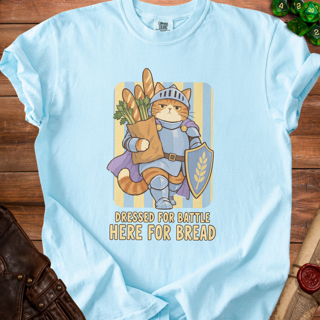 Cat knight holding a bag of bread and a shield, text says "Dressed for Battle Here for Bread".
