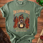 T-shirt graphic of three women around a cauldron with the text "The Caffeine Circle" and "Restore the Party".