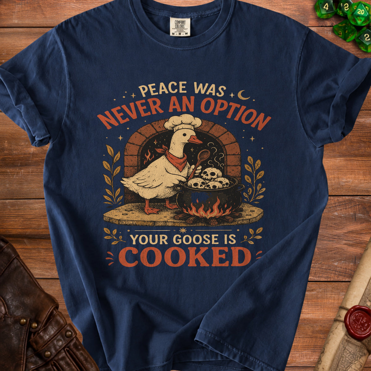 Navy t-shirt with a goose chef cooking skulls, text "Peace was never an option."