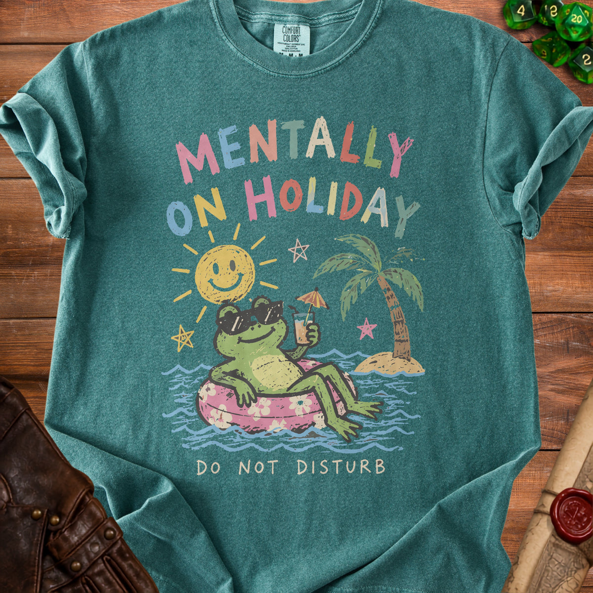 Green t-shirt with graphic of frog on inner tube saying "Mentally On Holiday Do Not Disturb".