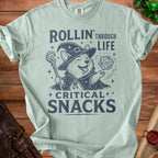 Light blue t-shirt with a corgi wizard and the text "Rollin' Through Life Critical Snacks".