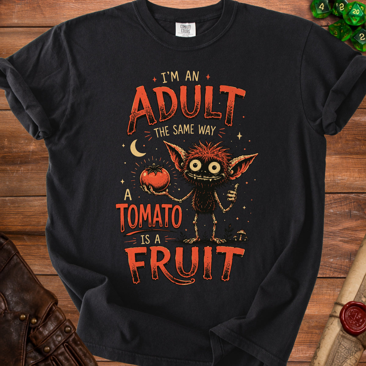 Black t-shirt with "I'm an adult the same way a tomato is a fruit" and monster graphic.