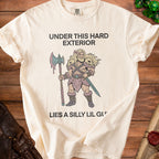 Cream t-shirt with text "UNDER THIS HARD EXTERIOR LIES A SILLY LIL GU" and barbarian illustration.