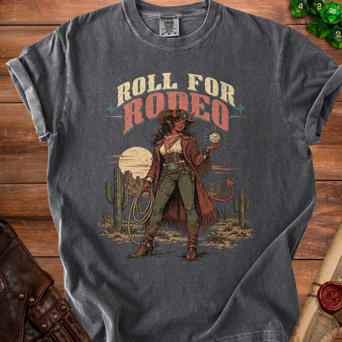 Dark grey t-shirt with "Roll For Rodeo" graphic featuring a devilish cowgirl holding a d20 die.