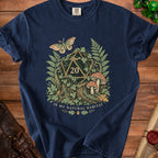 Navy t-shirt with a forest scene featuring a D20 die, moth, mushrooms, and text.