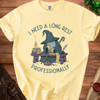 Yellow t-shirt with graphic of wizard and text "I NEED A LONG REST PROFESSIONALLY".