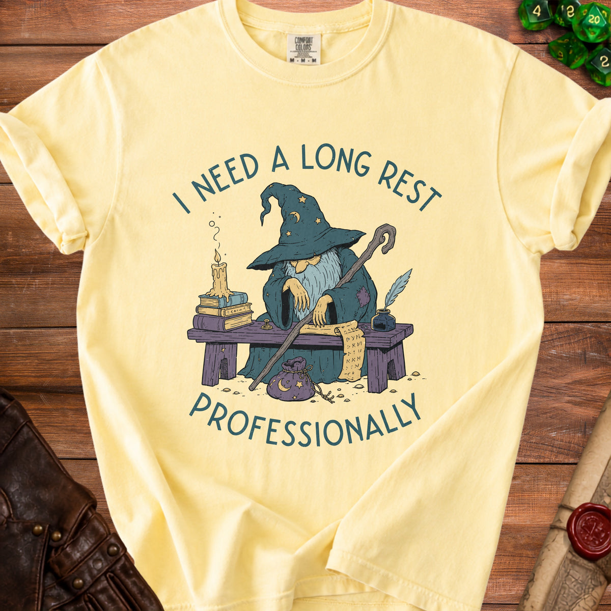 Yellow t-shirt with graphic of wizard and text "I NEED A LONG REST PROFESSIONALLY".