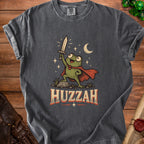 T-shirt with a frog character holding a sword with the word HUZZAH below.