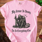 Pink t-shirt with black graphic of knight and text "My Armor Is Heavy So Is Everything Else".