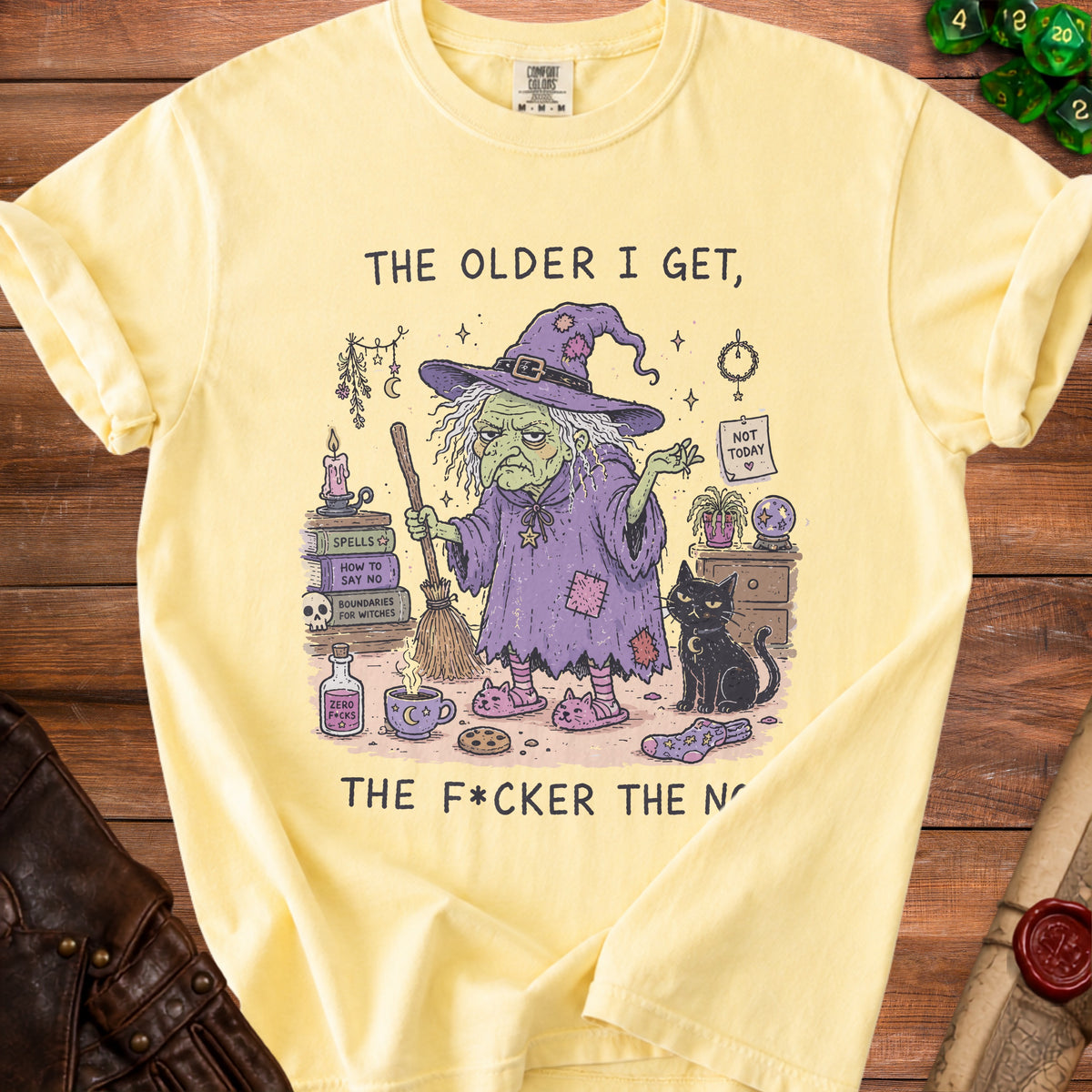 Yellow t-shirt with illustration of witch, black cat, and text "The older I get, the f*cker the n".