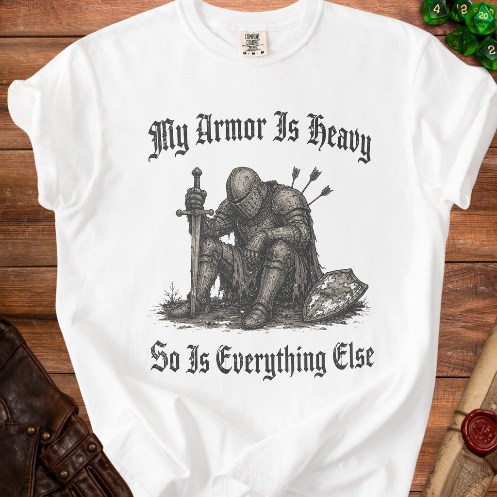 White t-shirt with a knight graphic and text "My Armor Is Heavy So Is Everything Else."
