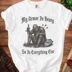 White t-shirt with a knight graphic and text "My Armor Is Heavy So Is Everything Else."
