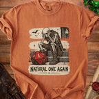 Orange t-shirt with a graphic of a skeleton sitting next to a d20 die, reading "Natural One Again".