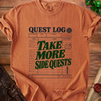 Comfort Colors orange t-shirt with "QUEST LOG" and "TAKE MORE SIDE QUESTS" graphics.